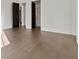 Hardwood flooring in a room with two dark wooden doors and white walls and trim at 56 Pine St, Roswell, GA 30075