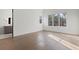 Bright bedroom featuring large windows, hardwood floors, and an ensuite bathroom with modern fixtures at 56 Pine St, Roswell, GA 30075