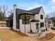 Elegant two-story home with a combination of brick and dark gray finishes and impeccable landscaping at 56 Pine St, Roswell, GA 30075