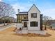 Beautiful modern home with a light-colored brick facade and stylish dark window frames at 56 Pine St, Roswell, GA 30075