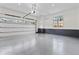 Clean, well-lit garage featuring epoxy floors, a window, and ample storage space at 56 Pine St, Roswell, GA 30075
