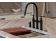 Close-up of a kitchen island with a modern black faucet, built in cutting board and drain at 56 Pine St, Roswell, GA 30075