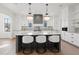 Spacious kitchen featuring a large island with seating, modern appliances, and stylish pendant lights at 56 Pine St, Roswell, GA 30075