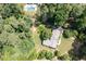 Aerial shot showcases the property's lush surroundings, manicured hedges, nearby pool, and architectural design at 59 Woodlawn Dr, Marietta, GA 30067