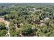 An aerial perspective revealing a wooded area dotted with homes along winding streets, creating a peaceful community feel at 59 Woodlawn Dr, Marietta, GA 30067