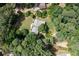 Aerial view of a well-maintained home surrounded by lush greenery, showcasing its privacy and serene setting at 59 Woodlawn Dr, Marietta, GA 30067