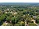 Panoramic aerial view of a lush, wooded neighborhood, highlighting multiple properties and their expansive surroundings at 59 Woodlawn Dr, Marietta, GA 30067