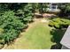 Lush backyard featuring manicured hedges and mature trees, creating a serene outdoor space at 59 Woodlawn Dr, Marietta, GA 30067