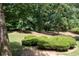 Lush backyard featuring manicured hedges and mature trees, creating a serene outdoor space at 59 Woodlawn Dr, Marietta, GA 30067