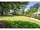 Expansive front yard with lush green grass and mature trees offering ample space at 59 Woodlawn Dr, Marietta, GA 30067