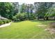 Manicured lawn with garden beds leading to home at 59 Woodlawn Dr, Marietta, GA 30067