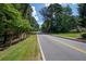View of a neighborhood street with mature trees and well maintained properties at 59 Woodlawn Dr, Marietta, GA 30067