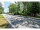 View of a neighborhood street with lush greenery, mature trees and well maintained properties at 59 Woodlawn Dr, Marietta, GA 30067