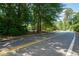 View of a neighborhood street with mature trees and well maintained properties at 59 Woodlawn Dr, Marietta, GA 30067