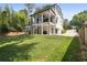 Expansive backyard featuring lush lawn and a modern white home with outdoor living spaces at 159 E Wesley Ne Rd, Atlanta, GA 30305