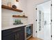 Modern bar area featuring floating wood shelves, wine fridge, and stylish decor at 159 E Wesley Ne Rd, Atlanta, GA 30305