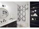 Stylish bathroom featuring unique tile design, modern fixtures, black vanity, and built-in shelving at 159 E Wesley Ne Rd, Atlanta, GA 30305