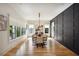Spacious dining room with hardwood floors, modern lighting, large windows, and black accent wall at 159 E Wesley Ne Rd, Atlanta, GA 30305