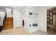 Bright entryway featuring wood floors, stairs, built-in bench with storage and view of a bathroom at 159 E Wesley Ne Rd, Atlanta, GA 30305