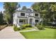View of house exterior featuring lovely lawn, landscaping, and a driveway at 159 E Wesley Ne Rd, Atlanta, GA 30305