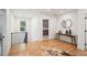Upstairs landing featuring wood floors, modern railing, and a view into the kitchen at 159 E Wesley Ne Rd, Atlanta, GA 30305