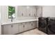 Well-organized laundry room with stylish cabinets, countertops, sink, and new washer/dryer at 159 E Wesley Ne Rd, Atlanta, GA 30305