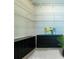 Walk-in closet equipped with custom shelving and dark wood drawers and a decorative art piece at 5300 Peachtree Rd # 503, Atlanta, GA 30341