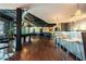 Large common area with a pool table, bar with barstools, and hardwood flooring throughout the open space at 5300 Peachtree Rd # 503, Atlanta, GA 30341