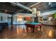 Recreation room with pool table, bar area, modern lighting, and hardwood flooring at 5300 Peachtree Rd # 503, Atlanta, GA 30341