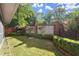 Manicured backyard features lush greenery, mature trees, and brick wall at 6 Westchester Sq, Decatur, GA 30030