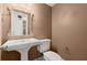 Stylish powder room with pedestal sink, decorative mirror, and neutral color scheme at 6 Westchester Sq, Decatur, GA 30030