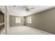 Neutral bedroom with a ceiling fan and built in shelving with windows at 6 Westchester Sq, Decatur, GA 30030