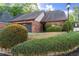 Brick home featuring an attached two car garage with manicured shrubbery in the front yard at 6 Westchester Sq, Decatur, GA 30030