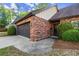 Brick home featuring an attached two car garage and decorative stone walkway to the front door at 6 Westchester Sq, Decatur, GA 30030