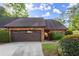 Brick home featuring an attached two car garage with meticulously maintained landscaping at 6 Westchester Sq, Decatur, GA 30030