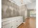 Bright hallway features a built-in storage unit, hardwood floors, and natural light from the window at 6 Westchester Sq, Decatur, GA 30030