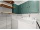 Bright laundry room with modern washer and dryer, green cabinets, and open shelving at 6 Westchester Sq, Decatur, GA 30030