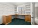This office features a custom desk with built-in shelves and cabinets and updated carpet at 6 Westchester Sq, Decatur, GA 30030