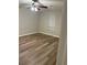 Cozy bedroom featuring modern flooring, a ceiling fan, and a window with blinds at 9161 Fairway Ct, Riverdale, GA 30274