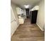 Efficient kitchen featuring white cabinets, stainless steel appliances, and wood flooring at 9161 Fairway Ct, Riverdale, GA 30274