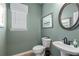 Neutral powder room features sage green walls, a modern sink, and simple design elements at 106 Asher Dr, Carrollton, GA 30116