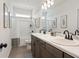 Modern bathroom with double sinks, marble countertops, and a shower-tub combo at 106 Asher Dr, Carrollton, GA 30116