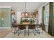 Dining room featuring hardwood floors, a large wooden table, and modern light fixtures at 106 Asher Dr, Carrollton, GA 30116