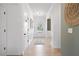Bright hallway with white wainscoting, wood floors, and a view of the front door at 106 Asher Dr, Carrollton, GA 30116