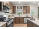 Well-equipped kitchen boasts stainless steel appliances, granite countertops, and ample cabinet space at 106 Asher Dr, Carrollton, GA 30116