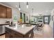 Island kitchen features granite countertops, a breakfast bar, and seamless flow into the dining and living area at 106 Asher Dr, Carrollton, GA 30116
