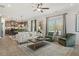 Bright living room with a modern sofa, fireplace, and hardwood floors; open to the kitchen at 106 Asher Dr, Carrollton, GA 30116