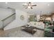 Inviting living room showcasing a staircase, hardwood floors, and a neutral sofa at 106 Asher Dr, Carrollton, GA 30116