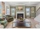 Cozy living room showcasing a fireplace, large windows, and hardwood floors at 106 Asher Dr, Carrollton, GA 30116