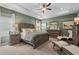 Comfortable main bedroom with a decorative tray ceiling, a ceiling fan, and neutral-toned walls at 106 Asher Dr, Carrollton, GA 30116
